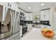 Modern kitchen featuring stainless steel appliances, white cabinetry, and stylish backsplash at 4017 Cedar Limb Ct, Tampa, FL 33614