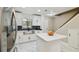 Bright kitchen with stainless steel appliances, island, and modern finishes at 4017 Cedar Limb Ct, Tampa, FL 33614