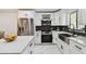 Modern kitchen with quartz countertops, stainless steel appliances, and wine rack at 4017 Cedar Limb Ct, Tampa, FL 33614