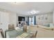 Open-concept living area with glass dining table, modern decor, and sliding glass door at 4017 Cedar Limb Ct, Tampa, FL 33614