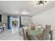 Bright living room with glass dining table, blue curtains, and lots of natural light at 4017 Cedar Limb Ct, Tampa, FL 33614