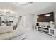 Inviting open-concept living area with white tile flooring, a TV, and a seamless transition to the dining area at 4017 Cedar Limb Ct, Tampa, FL 33614