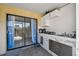 Covered outdoor kitchen with stainless steel appliances, tile backsplash, and sliding glass doors to the patio at 4017 Cedar Limb Ct, Tampa, FL 33614