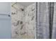Contemporary shower with marble-patterned tile, rainfall showerhead, and sleek fixtures at 4017 Cedar Limb Ct, Tampa, FL 33614