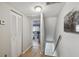 Upstairs hallway with wood floors, an elephant art piece, and access to the bedrooms via white doors at 4017 Cedar Limb Ct, Tampa, FL 33614