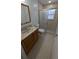 A clean bathroom featuring a vanity sink, toilet, and glass-enclosed shower with pebble flooring at 4021 19Th N St, St Petersburg, FL 33714