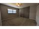 A bedroom with a window, wood-paneled wall, neutral carpet and ceiling fan with light at 4021 19Th N St, St Petersburg, FL 33714