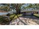 Home exterior featuring covered parking, a low fence, and mature landscaping at 4021 19Th N St, St Petersburg, FL 33714