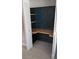 View of a closet converted to an office space with a wooden desk, wallpaper and shelving at 4021 19Th N St, St Petersburg, FL 33714