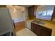 This kitchen has stainless steel sink, white appliances, and wood cabinetry at 4021 19Th N St, St Petersburg, FL 33714