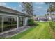 Backyard features a sunroom with nice lawn at 4234 Brentwood Park Cir, Tampa, FL 33624