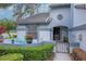 Charming home exterior features a gated courtyard with seating and garden, showcasing the property's curb appeal at 4234 Brentwood Park Cir, Tampa, FL 33624