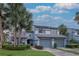 Charming two-story townhome with a well-kept lawn, mature trees, and attached two-car garage at 4234 Brentwood Park Cir, Tampa, FL 33624