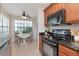 Eat-in kitchen featuring stainless appliances, natural wood cabinetry, and a cozy breakfast nook at 4234 Brentwood Park Cir, Tampa, FL 33624