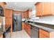 Spacious kitchen featuring stainless appliances, granite countertops and natural wood cabinetry at 4234 Brentwood Park Cir, Tampa, FL 33624