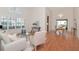 Bright living room featuring high ceilings, large windows with shutters, and hardwood flooring throughout at 4234 Brentwood Park Cir, Tampa, FL 33624