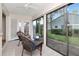 Cozy sunroom with wicker chairs and view of the backyard at 4234 Brentwood Park Cir, Tampa, FL 33624