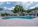Community pool with brick paved deck, lounge chairs, and manicured landscaping at 4234 Brentwood Park Cir, Tampa, FL 33624