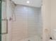 Modern bathroom shower with white subway tile and frameless glass door at 4234 Brentwood Park Cir, Tampa, FL 33624
