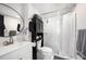 The bathroom includes updated glass shower doors, modern vanity and new fixtures at 4521 W North St, Tampa, FL 33614