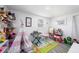 Charming bedroom with a play area, teepee and a rug with bright designs at 4521 W North St, Tampa, FL 33614