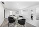 Dining room with glass table set for six, contemporary chairs, and plenty of natural light at 4521 W North St, Tampa, FL 33614