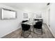Dining room with glass table set for six, contemporary chairs, and plenty of natural light at 4521 W North St, Tampa, FL 33614