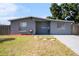 Charming single-story home features a well-maintained front yard and neutral gray exterior at 4521 W North St, Tampa, FL 33614