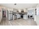 Modern kitchen featuring stainless steel appliances, gray cabinetry, and stylish backsplash at 4521 W North St, Tampa, FL 33614