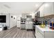 Updated kitchen features gray cabinetry, stainless steel appliances and a tile backsplash at 4521 W North St, Tampa, FL 33614