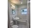Bright bathroom featuring a pedestal sink, tiled walls, and a shower-tub combination at 4611 17Th N Ave, St Petersburg, FL 33713