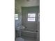 Bathroom with white tiled walls, pedestal sink, and tub at 4611 17Th N Ave, St Petersburg, FL 33713