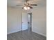 Bedroom featuring ceiling fan, white trim, gray tile flooring and arched doorway at 4611 17Th N Ave, St Petersburg, FL 33713