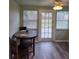 Cozy dining area with a ceiling fan, wood-look flooring, and a door to the outside at 4611 17Th N Ave, St Petersburg, FL 33713