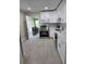 Modern kitchen featuring white cabinets, stainless steel appliances, and gray backsplash at 4611 17Th N Ave, St Petersburg, FL 33713