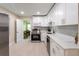 Well-lit kitchen with sleek appliances, white cabinets, and a view into the dining area at 4611 17Th N Ave, St Petersburg, FL 33713