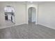 Bright living room with modern gray floors and arched doorways leading to the kitchen at 4611 17Th N Ave, St Petersburg, FL 33713