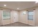 Well-lit living room boasts updated lighting, wood-look tile floors, and natural light from multiple windows at 4611 17Th N Ave, St Petersburg, FL 33713