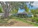 Spacious backyard with mature trees, shade and landscaping, including a covered patio at 512 Hillpine Way, Brandon, FL 33510
