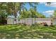 Large backyard with lush green grass, storage sheds, mature trees and manicured landscaping at 512 Hillpine Way, Brandon, FL 33510
