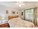Comfortable bedroom with bed, side table, window and ceiling fan at 512 Hillpine Way, Brandon, FL 33510
