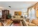 Comfortable living area with hardwood flooring, a sofa, and a dining room in the background at 512 Hillpine Way, Brandon, FL 33510