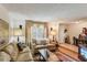 Warm and inviting living room featuring a step up, two lamps and carpet at 512 Hillpine Way, Brandon, FL 33510