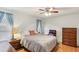 Light main bedroom features wood floors, ceiling fan and ensuite bathroom at 512 Hillpine Way, Brandon, FL 33510