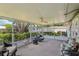 Screened patio featuring comfortable seating, ceiling fan and views of the beautifully landscaped yard at 512 Hillpine Way, Brandon, FL 33510