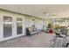 Covered patio includes neutral colors, ceiling fan, and seating with views of the landscaped yard at 512 Hillpine Way, Brandon, FL 33510
