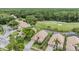 Overhead shot of houses nestled near a golf course, showcasing well-maintained landscaping and trees at 5156 Pinnacle Dr, Oldsmar, FL 34677