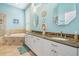 Bright bathroom features a double vanity, bathtub, large mirror, and decorative accents at 5156 Pinnacle Dr, Oldsmar, FL 34677