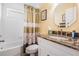 Bathroom featuring granite countertop, white vanity and toilet, and tiled shower-tub combo at 5156 Pinnacle Dr, Oldsmar, FL 34677