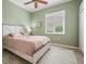 Cozy bedroom with ceiling fan, window shutters, and a comfortable-looking bed at 5156 Pinnacle Dr, Oldsmar, FL 34677